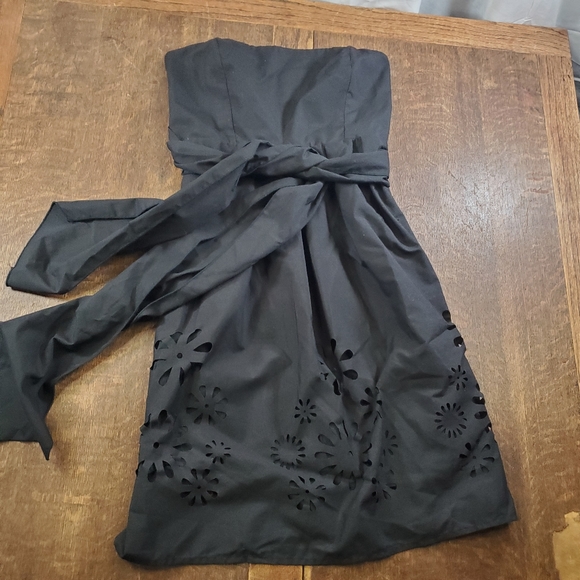 Rhapsody Dresses & Skirts - Rhapsody black strapless mini dress with floral cutout design at hemline